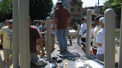 volunteers building a community build playground